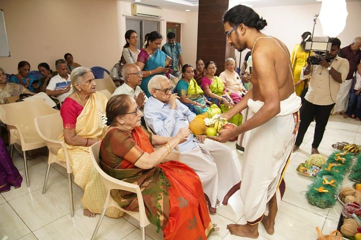 A priest offering fruit to the elders